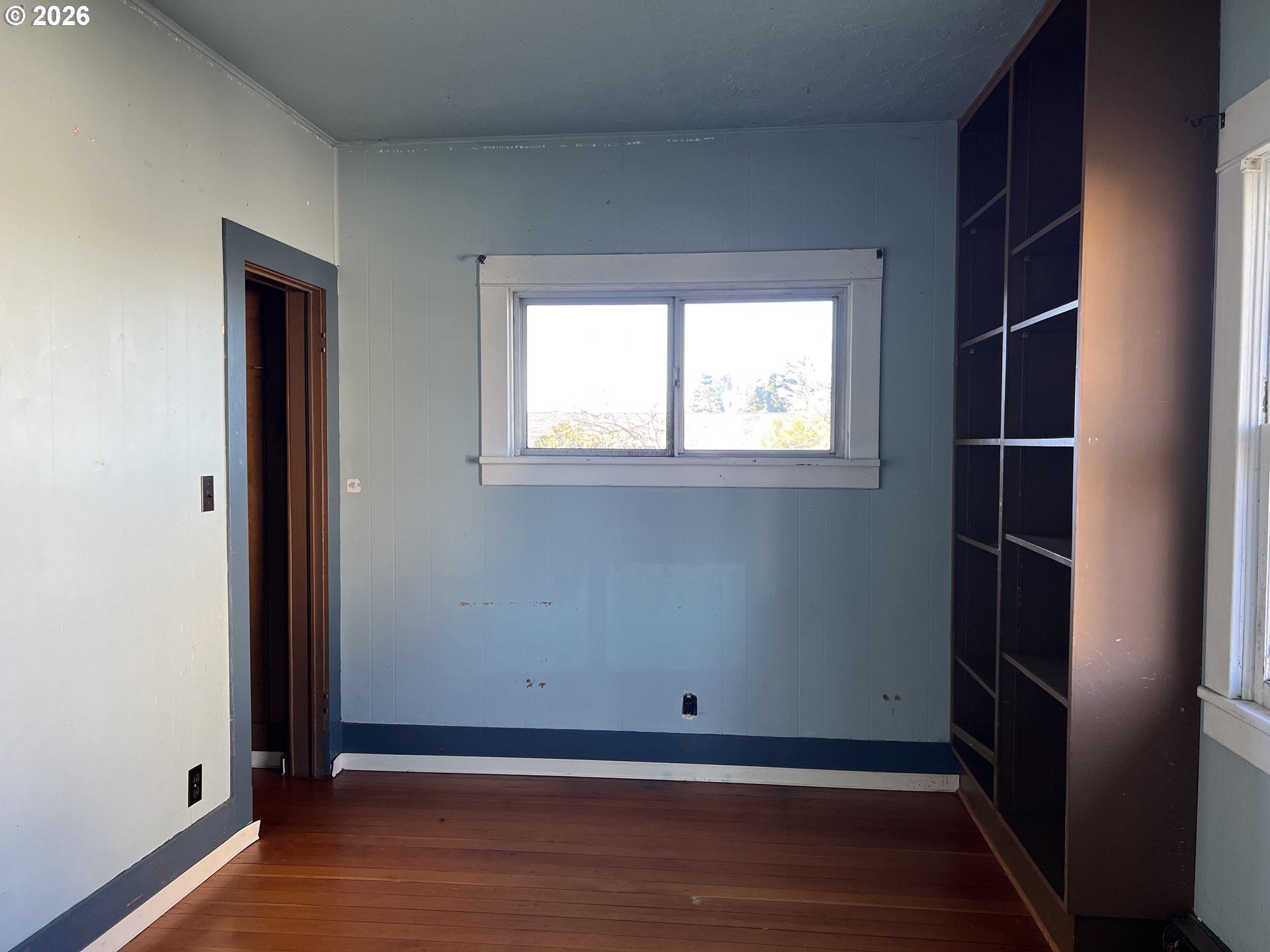 2260 Meade Avenue North Bend, OR 97459 - Photo 21 of 37 an empty room with wooden floor and windows