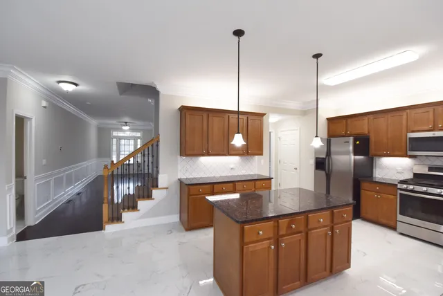 a kitchen with stainless steel appliances granite countertop refrigerator a sink and wooden floor