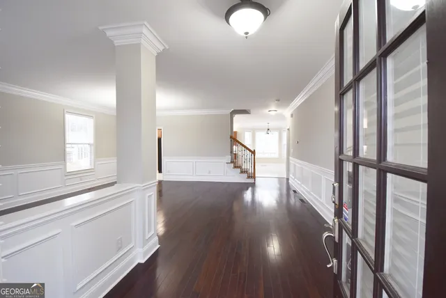 a view of an entryway with wooden floor