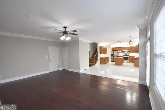 a view of an empty room with wooden floor