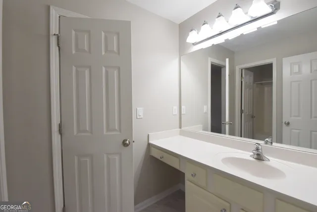 a bathroom with a tub sink and mirror