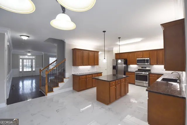 a large kitchen with kitchen island a sink counter space and stainless steel appliances