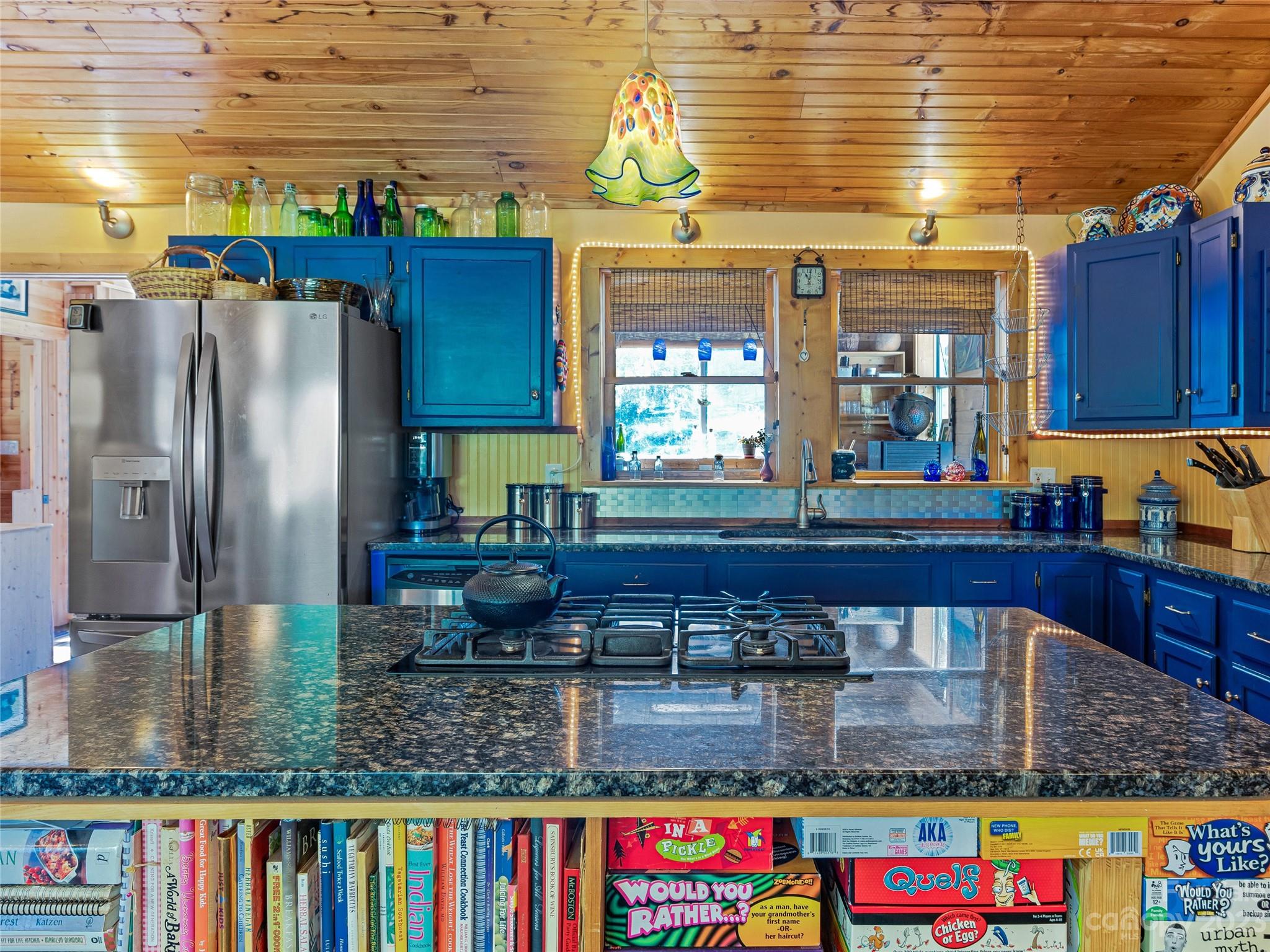 305 Pound Mill Road Marshall, NC 28753 - Photo 15 of 48 a kitchen with stainless steel appliances granite countertop a refrigerator table and chairs