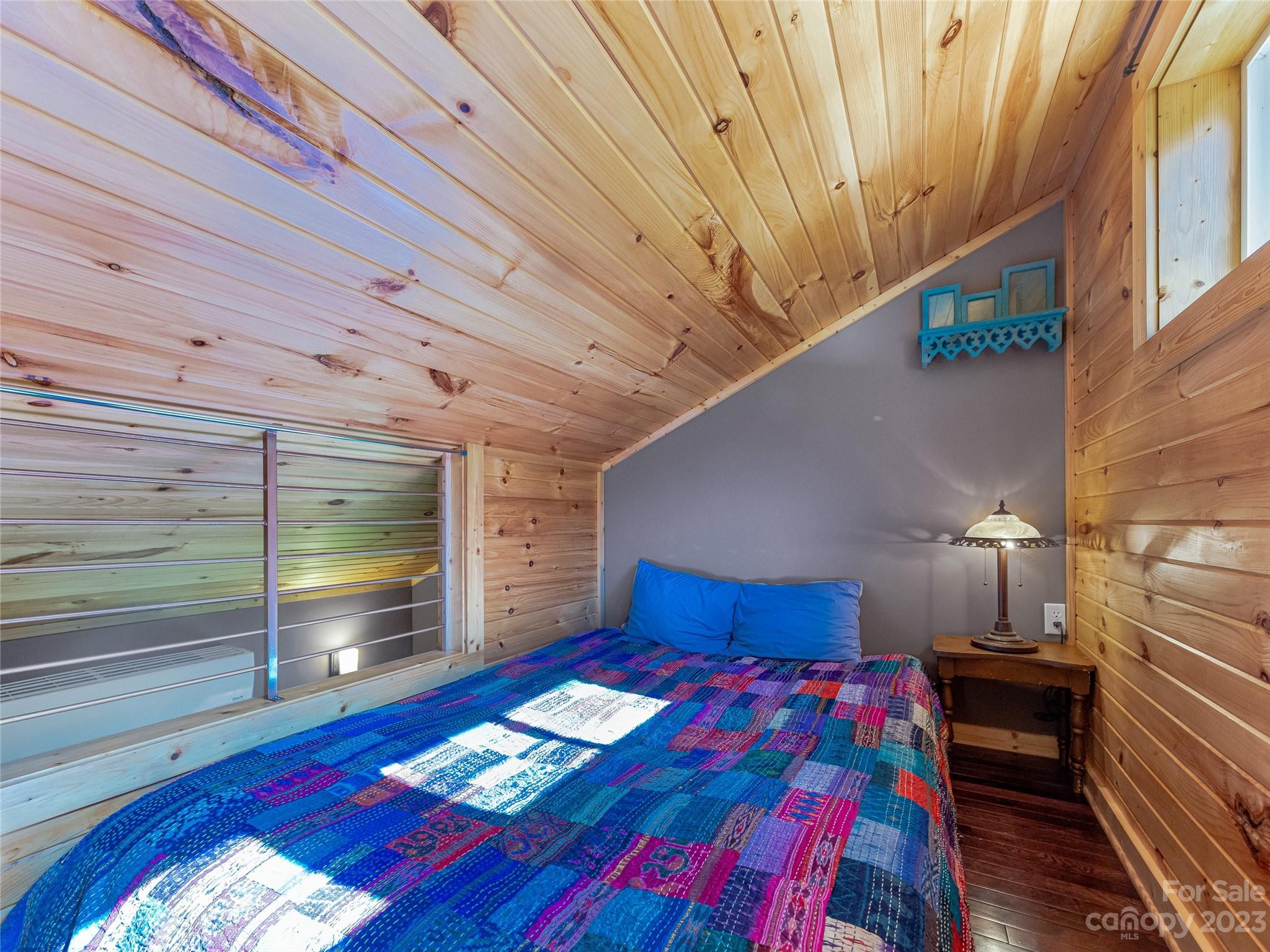 305 Pound Mill Road Marshall, NC 28753 - Photo 24 of 48 a bedroom with a bed and a night stand