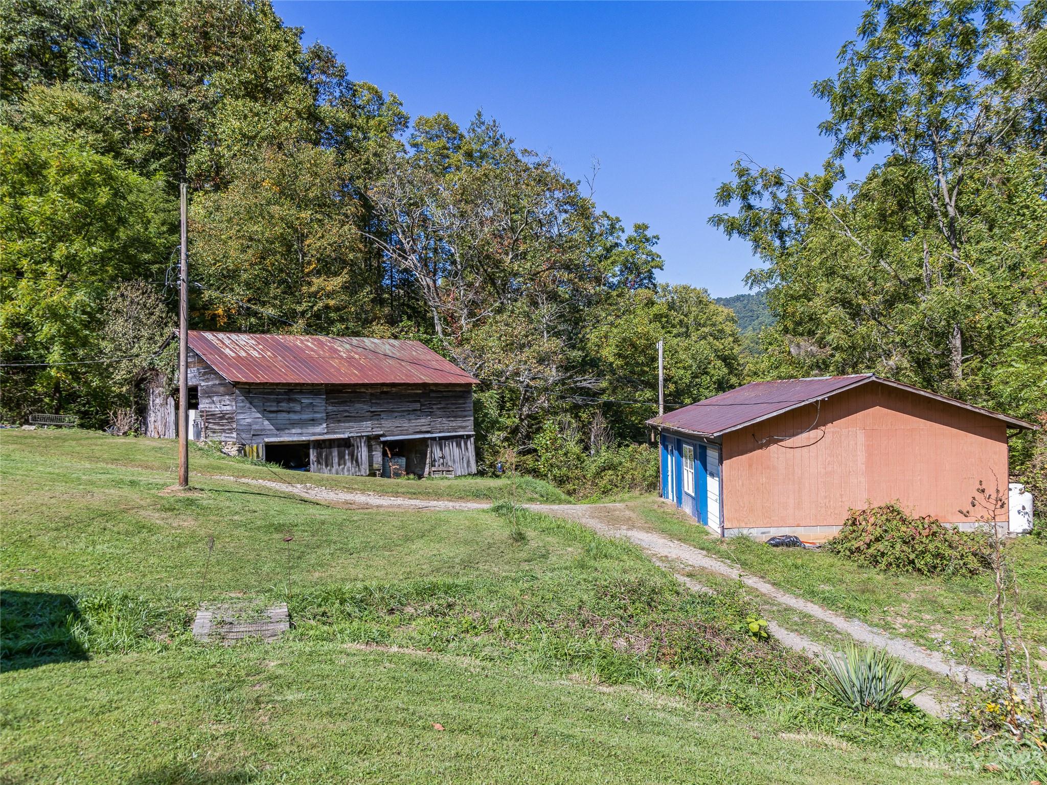 305 Pound Mill Road Marshall, NC 28753 - Photo 29 of 48 a backyard of a house with yard and trampoline
