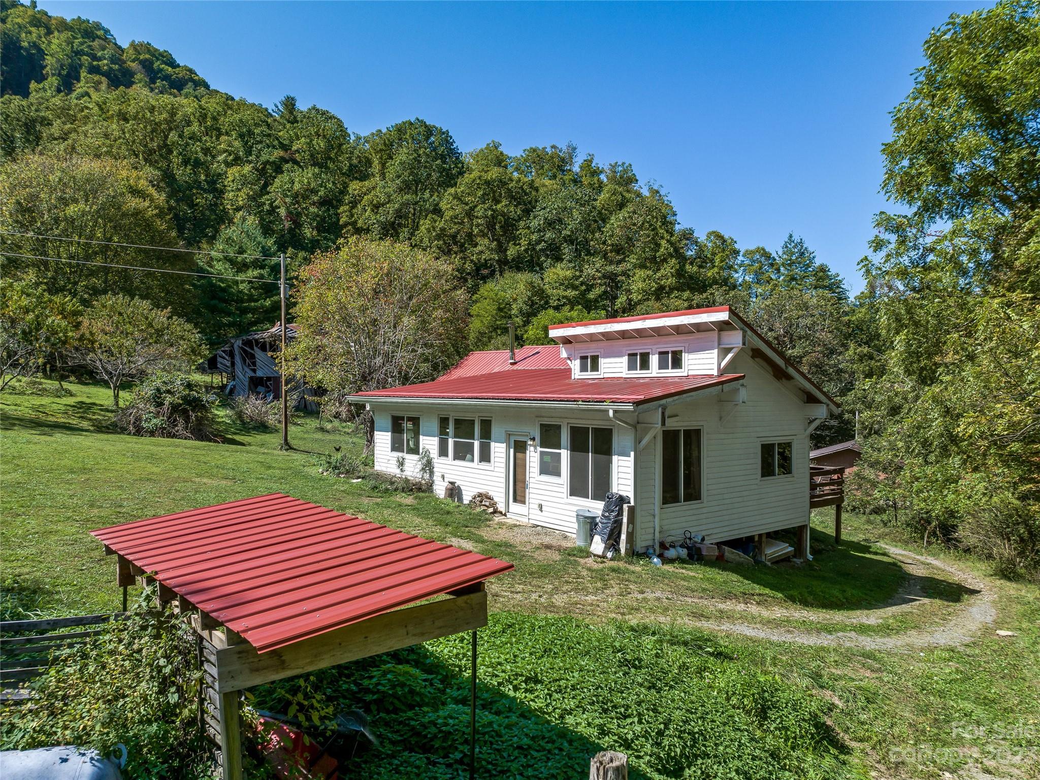 305 Pound Mill Road Marshall, NC 28753 - Photo 6 of 48 a view of a patio with a table and chairs under an umbrella