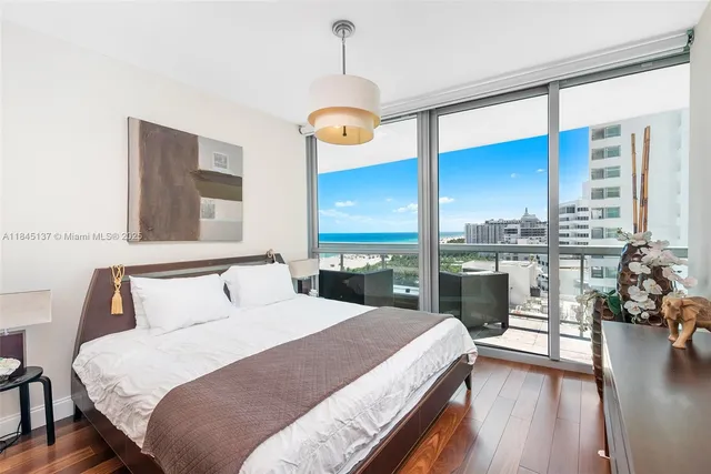 a bedroom with a large bed and a large window