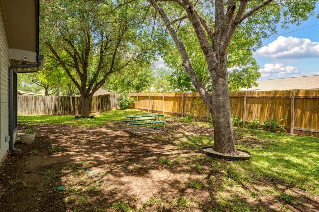 1502 Quail Run Road Pflugerville, TX 78660 - Photo 31 of 37 A well-maintained fenced backyard offers ample space and mature shade trees.