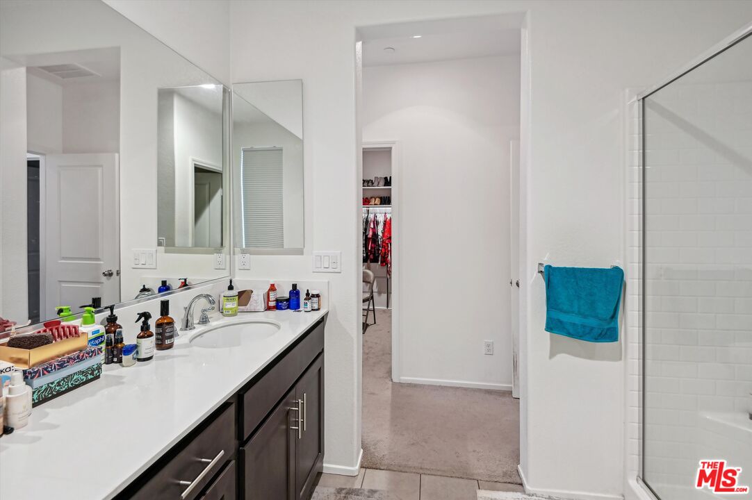 7329 Garnet Ridge Road Jurupa Valley, CA 92509 - Photo 15 of 35 a bathroom with a sink and a mirror