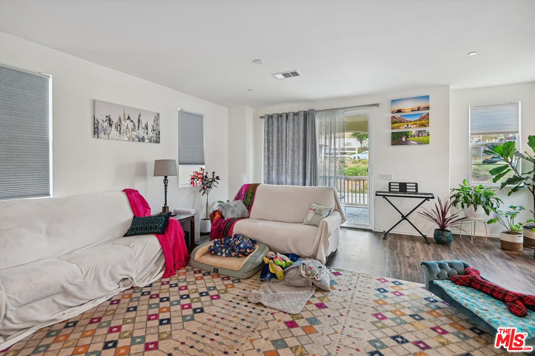 7329 Garnet Ridge Road Jurupa Valley, CA 92509 - Photo 7 of 35 a living room with furniture and wooden floor