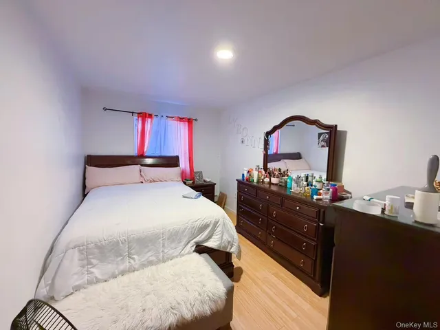 a bedroom with a bed and a dresser