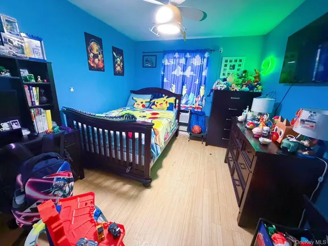 a bedroom with furniture and a baby crib