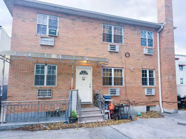 a front view of a house with outdoor seating