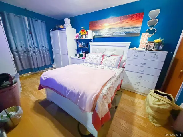 a bed sitting in a bedroom next to a window