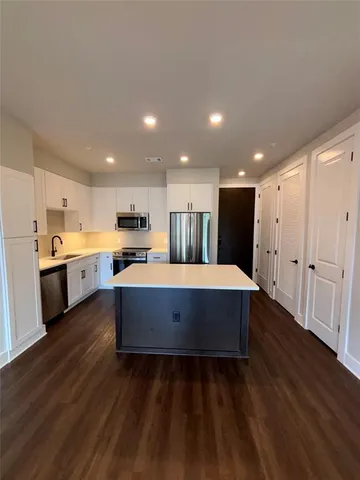 a view of kitchen with wooden floor and electronic appliances