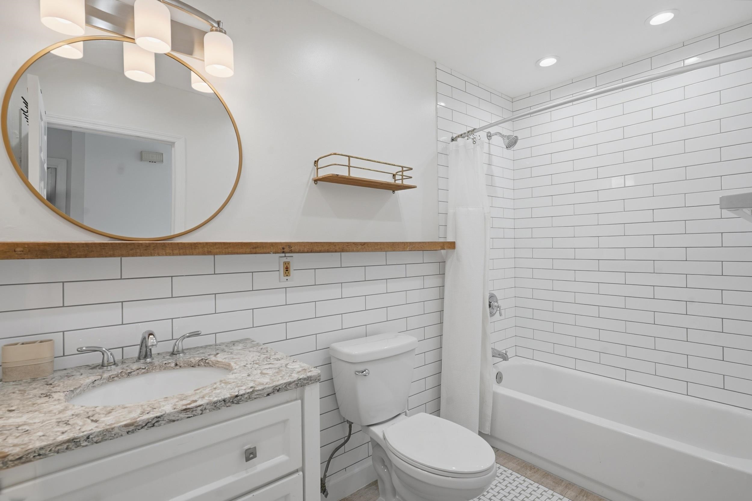 904 Alicante Road St. Augustine, FL 32086 - Photo 14 of 32 Full bathroom featuring tile walls, vanity, shower / bath combo, and recessed lighting