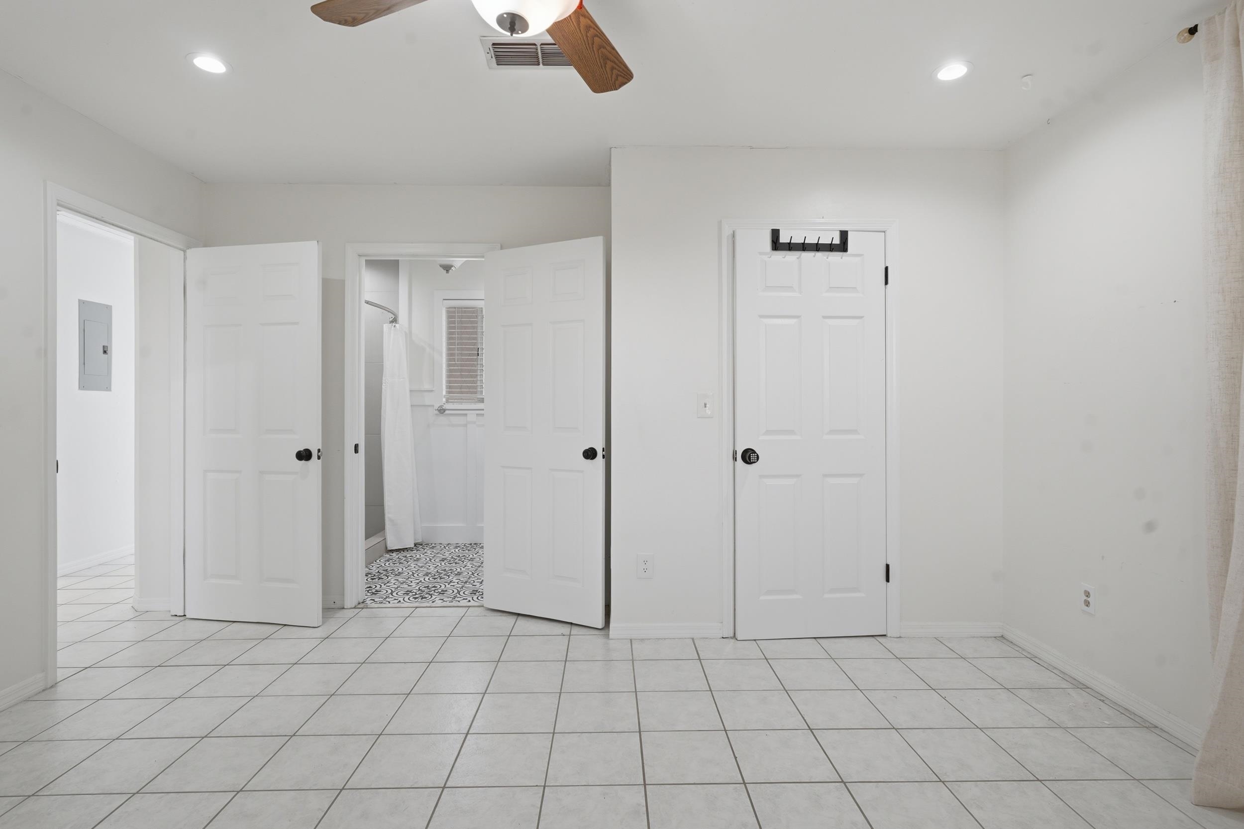 904 Alicante Road St. Augustine, FL 32086 - Photo 19 of 32 Unfurnished bedroom featuring a ceiling fan, recessed lighting, electric panel, connected bathroom, and light tile patterned floors