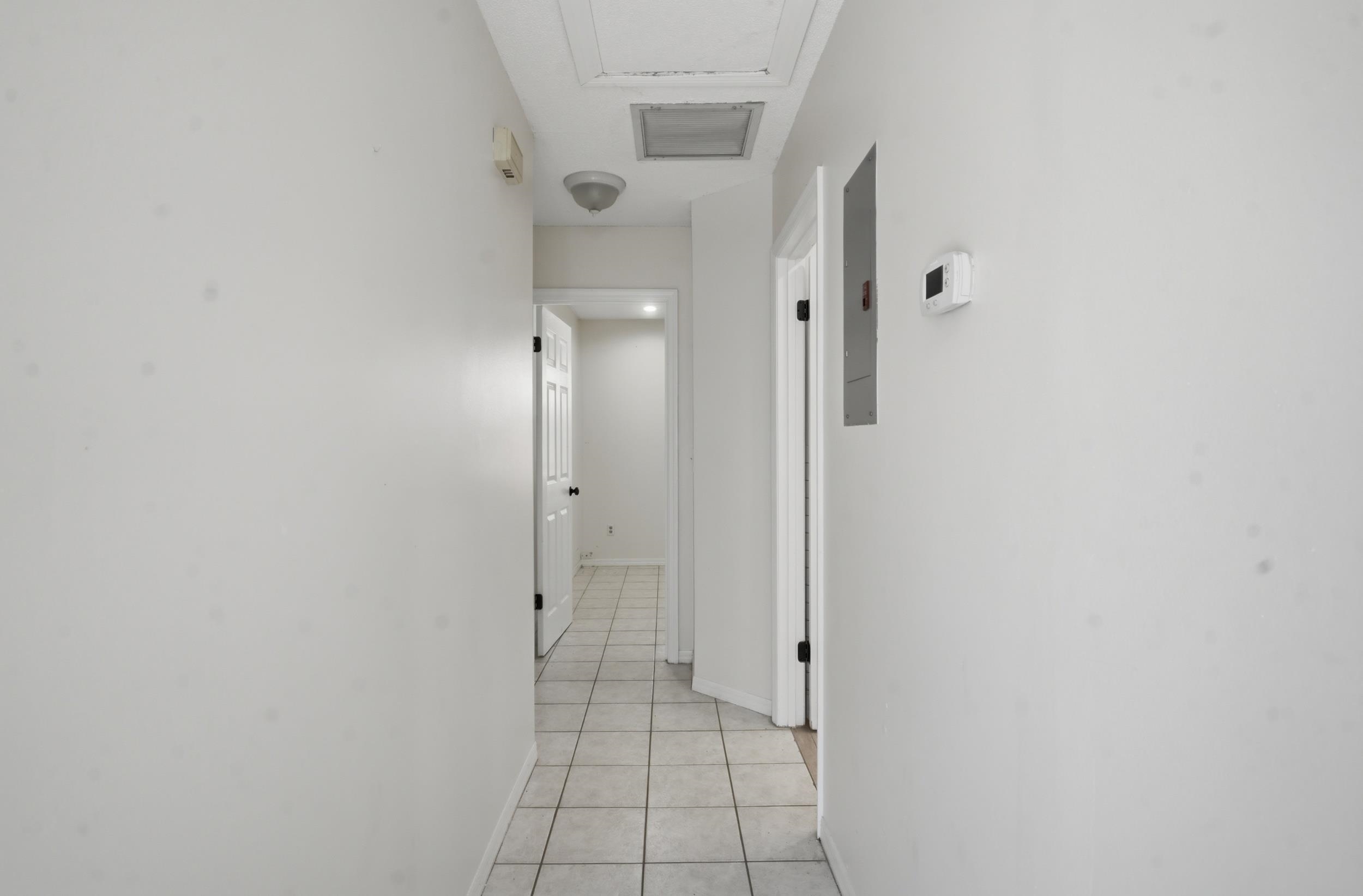 904 Alicante Road St. Augustine, FL 32086 - Photo 23 of 32 Corridor with light tile patterned flooring and baseboards