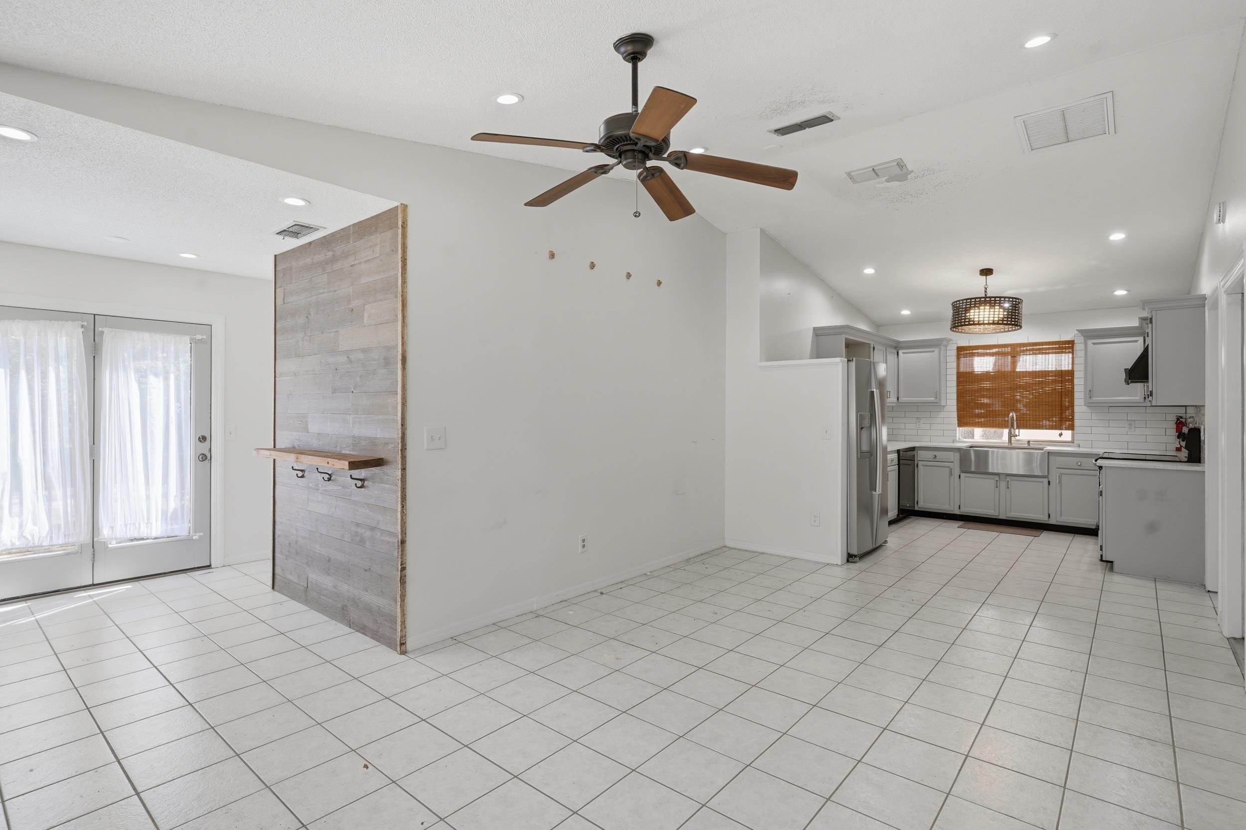 904 Alicante Road St. Augustine, FL 32086 - Photo 9 of 32 Kitchen with gray cabinets, light countertops, a ceiling fan, light tile patterned floors, and tasteful backsplash