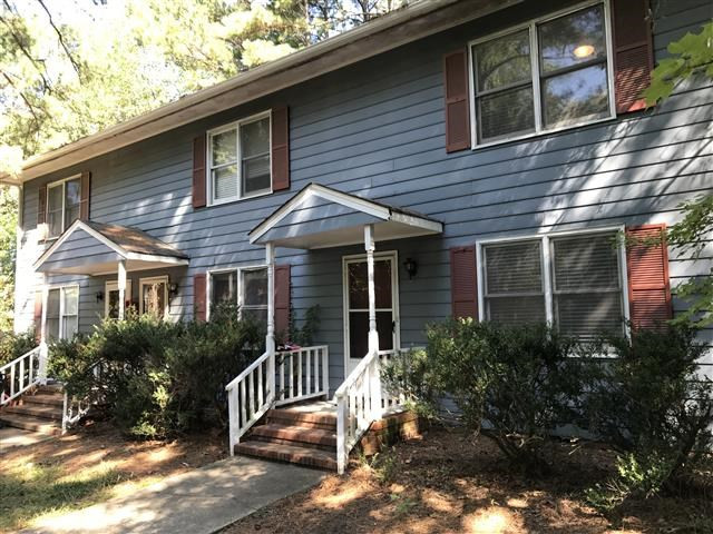 3808 Marcom Street Raleigh, NC 27606 - Photo 3 of 13 a view of a house with a yard and potted plants