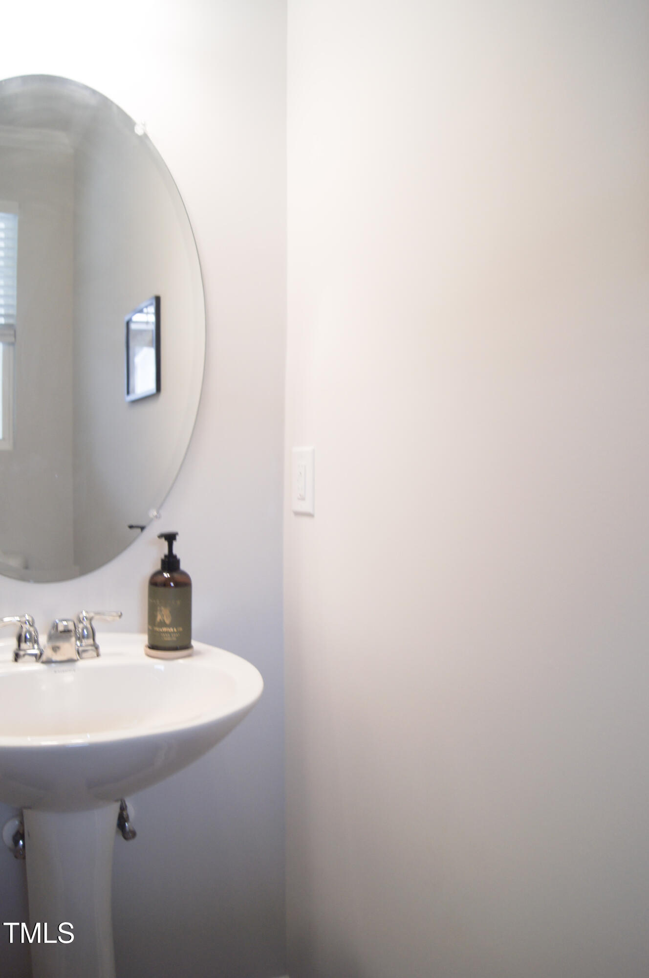5006 Tura Street Raleigh, NC 27610 - Photo 10 of 67 a bathroom with a sink and a mirror