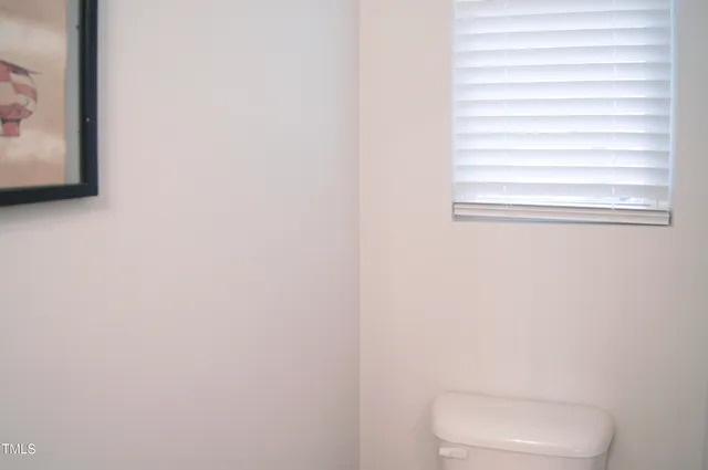 a kitchen with stainless steel appliances a table chairs refrigerator and microwave