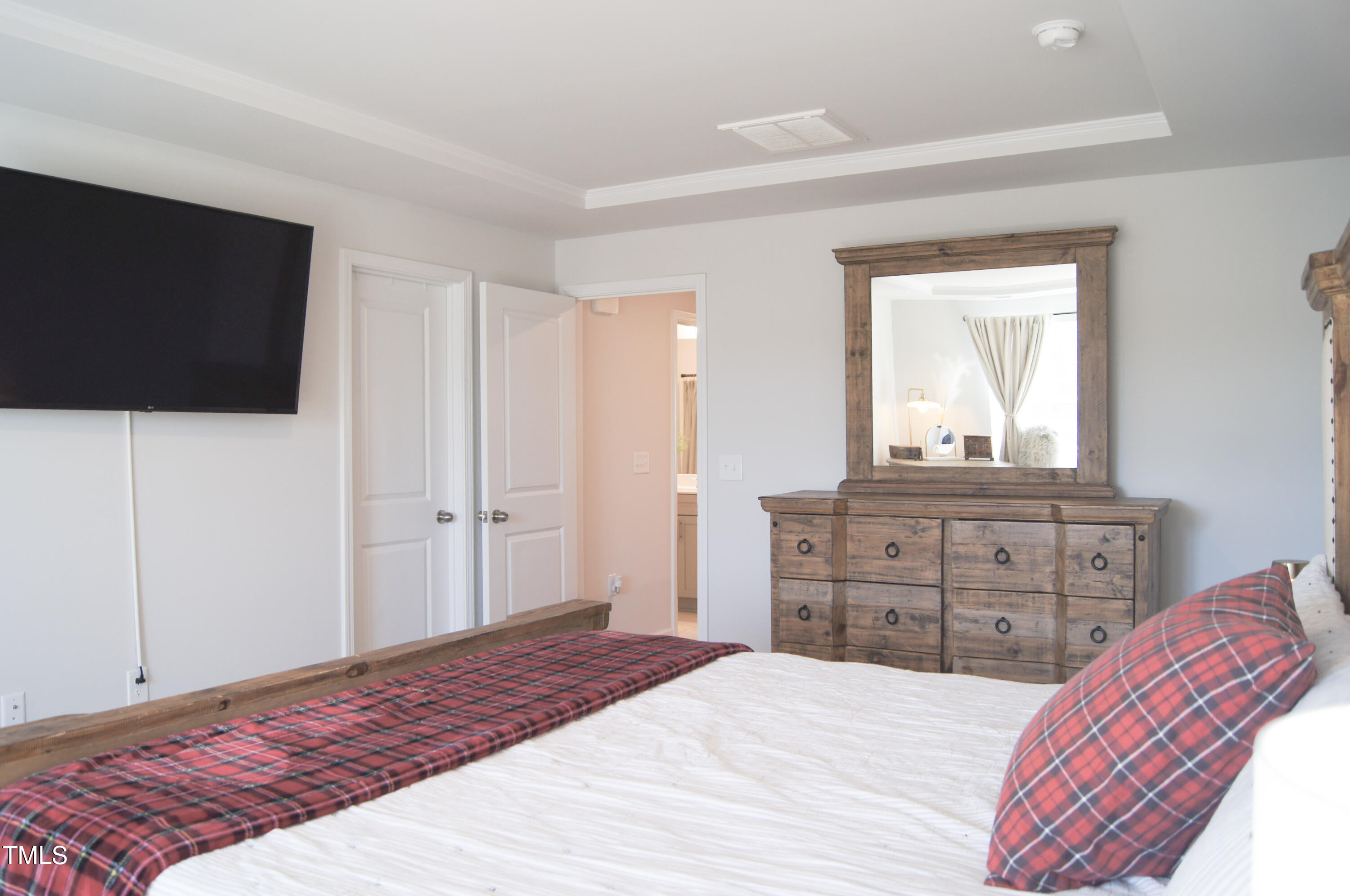 5006 Tura Street Raleigh, NC 27610 - Photo 23 of 67 a bedroom with a bed and a flat screen tv