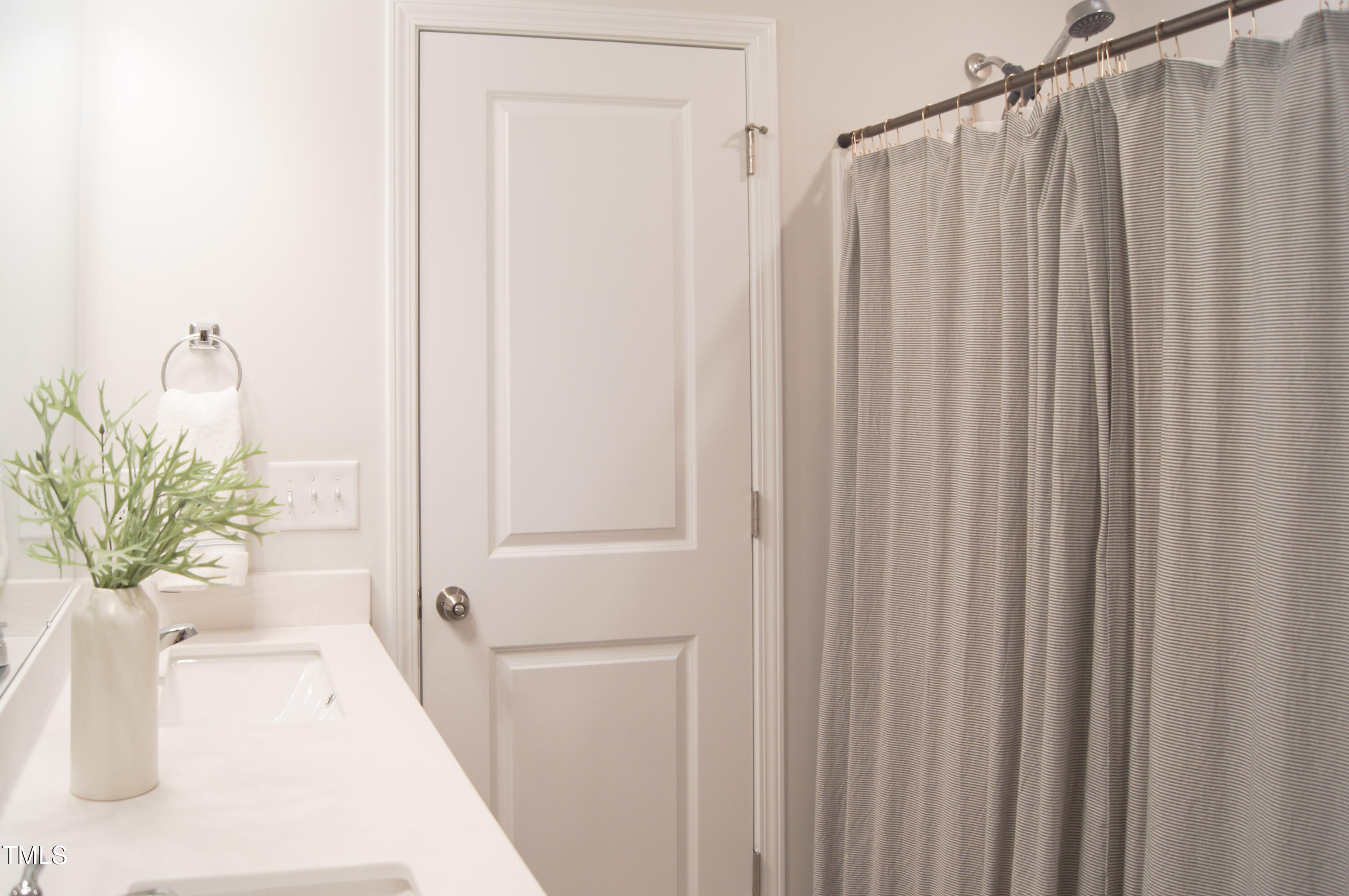 5006 Tura Street Raleigh, NC 27610 - Photo 36 of 67 a bathroom with a shower curtain and a window