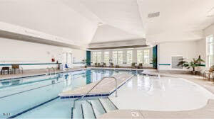5006 Tura Street Raleigh, NC 27610 - Photo 55 of 67 a dining room with wooden floor and a floor to ceiling window
