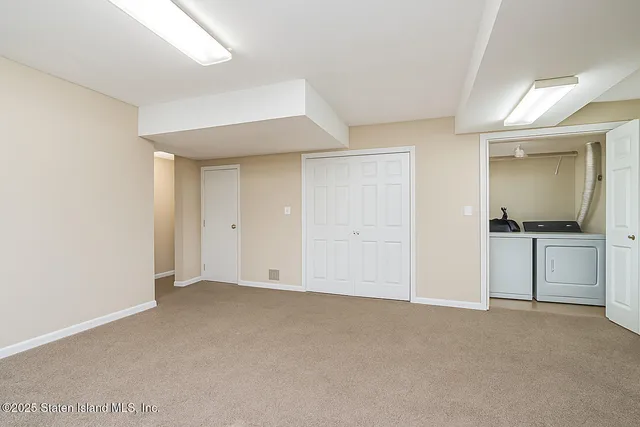 a view of an empty room and a fireplace