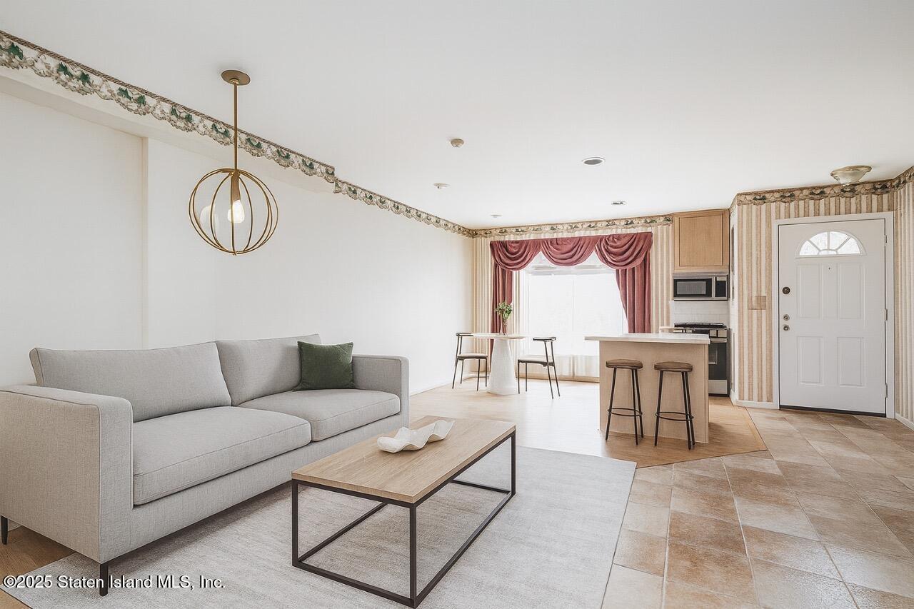41 Wolcott Avenue Staten Island, NY 10312 - Photo 3 of 33 a living room with furniture a table and chairs