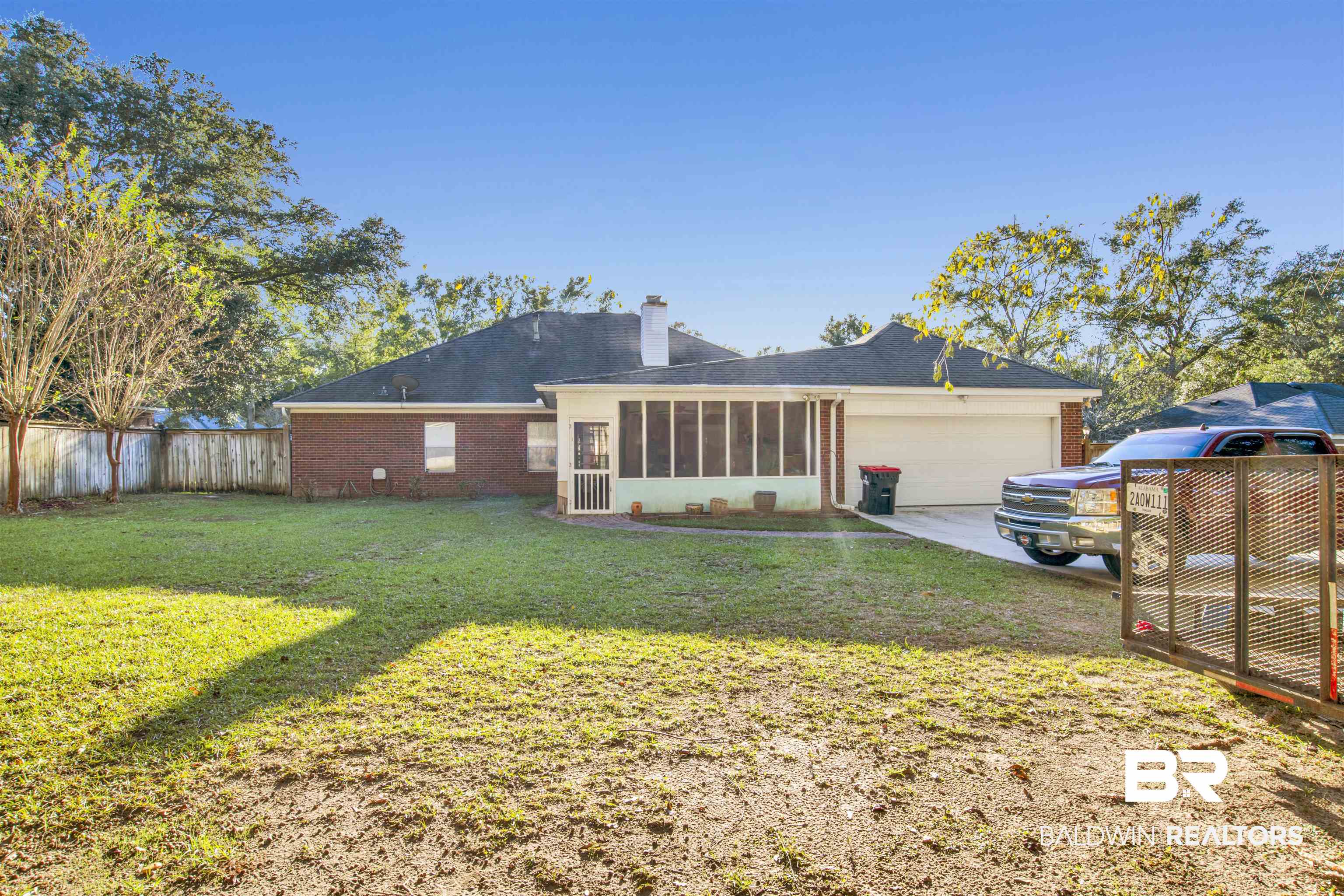 445 Wedgefield Drive South Mobile, AL 36608 - Photo 36 of 36 Rear view of house featuring a sunroom, a garage, and a yard