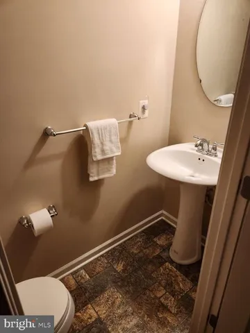 a bathroom with a sink mirror vanity and toilet