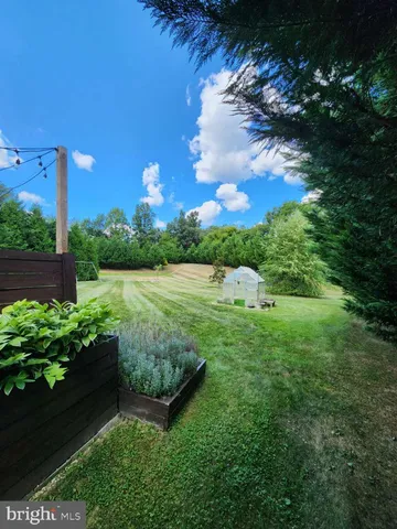 a view of a garden with a building in the background