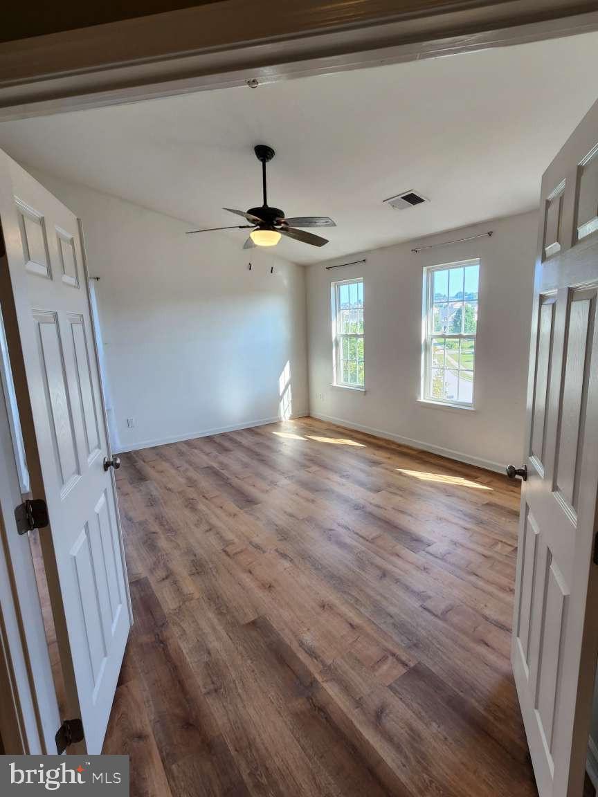 2040 Waterfall Drive Hanover, PA 17331 - Photo 8 of 25 a view of an empty room with wooden floor and a window