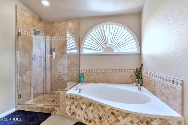 a bathroom with a tub a sink and a shower