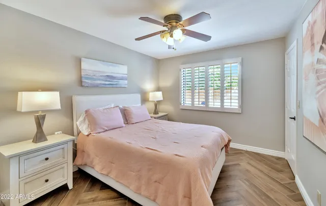 a bedroom with a large bed and a window