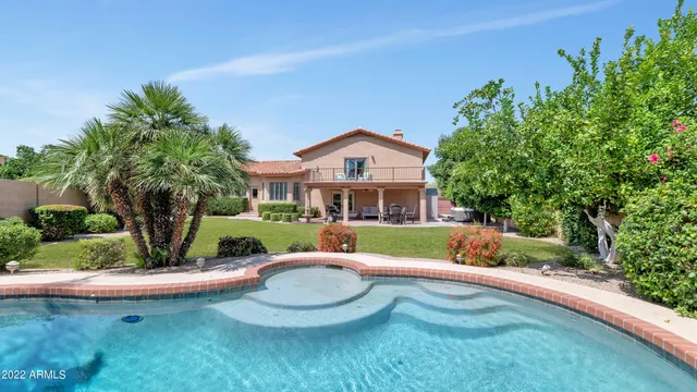 a view of a house with backyard sitting area and garden