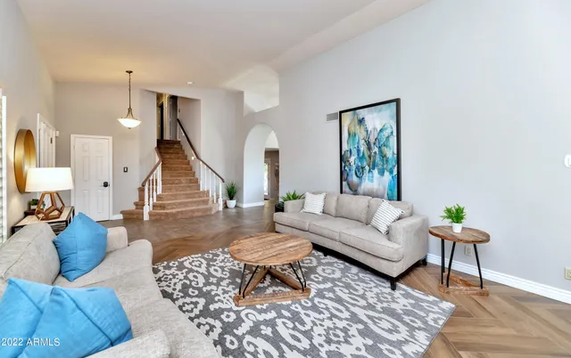 a living room with furniture and wooden floor