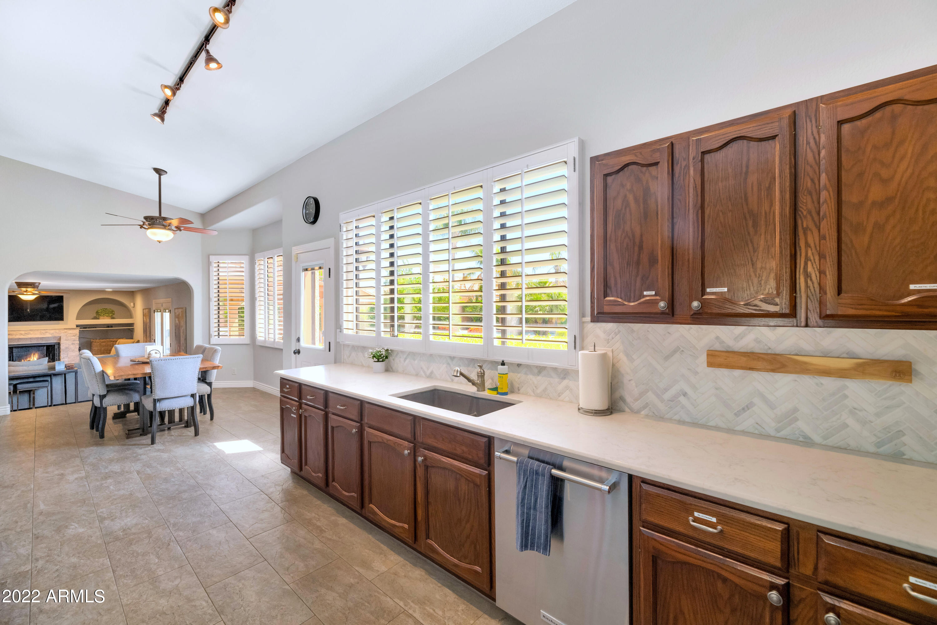 14227 North 57th Way Scottsdale, AZ 85254 - Photo 7 of 25 a kitchen that has a sink and a stove in it