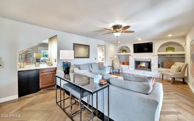 a living room with furniture a fireplace and a flat screen tv