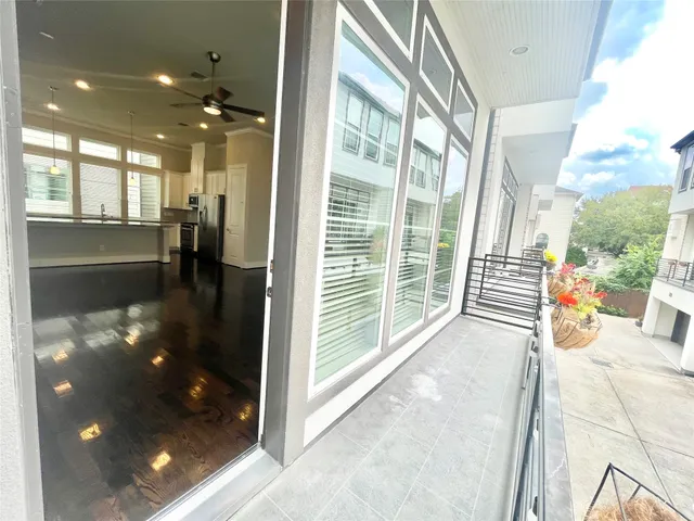a large white kitchen with kitchen island granite countertop a large window