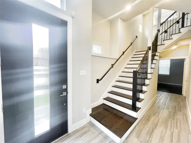 a bathroom with a sink a toilet a mirror and shower