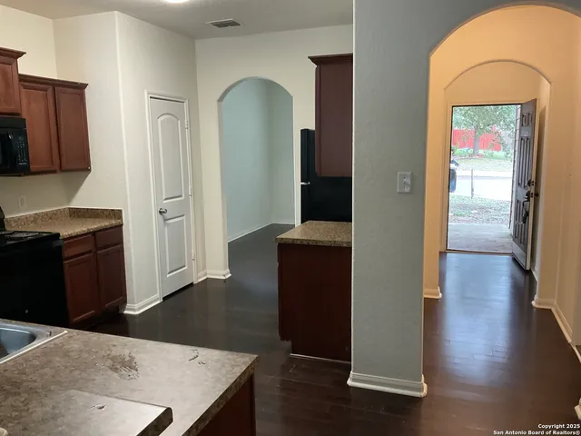 a view of a kitchen cabinets and wooden floor