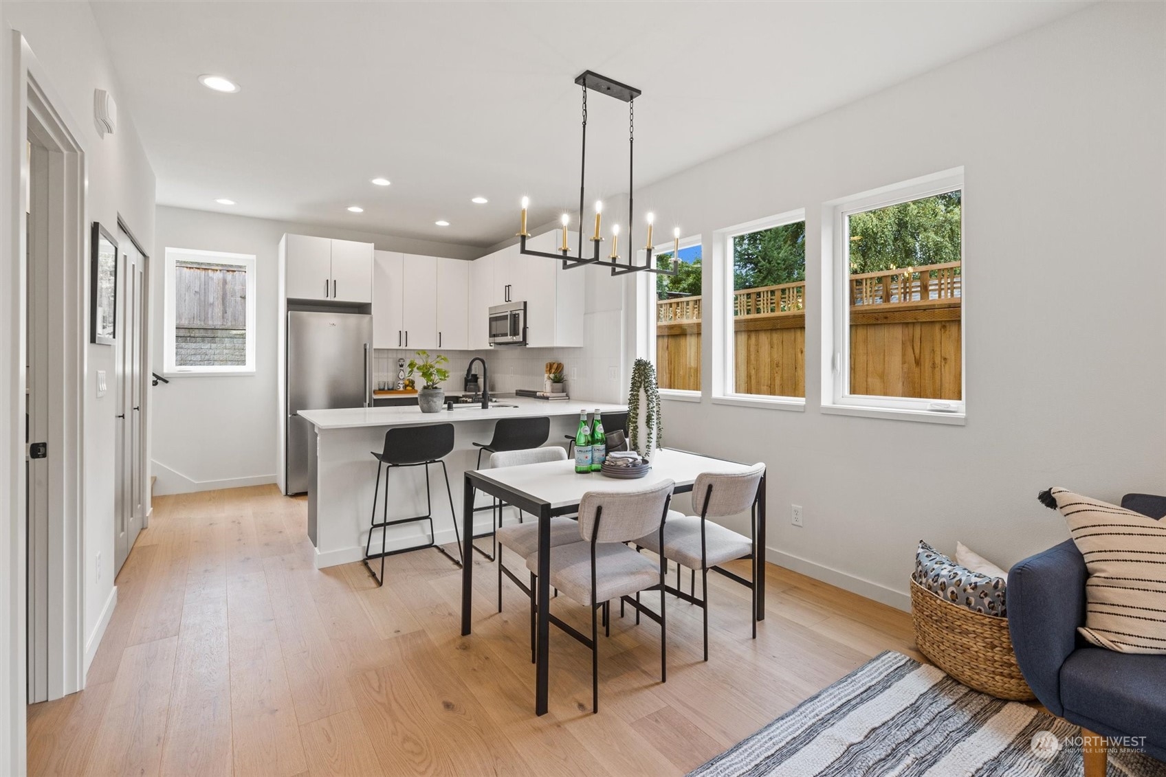 8021 17th Avenue Northwest Seattle, WA 98117 - Photo 12 of 23 a dining room with furniture a chandelier and wooden floor