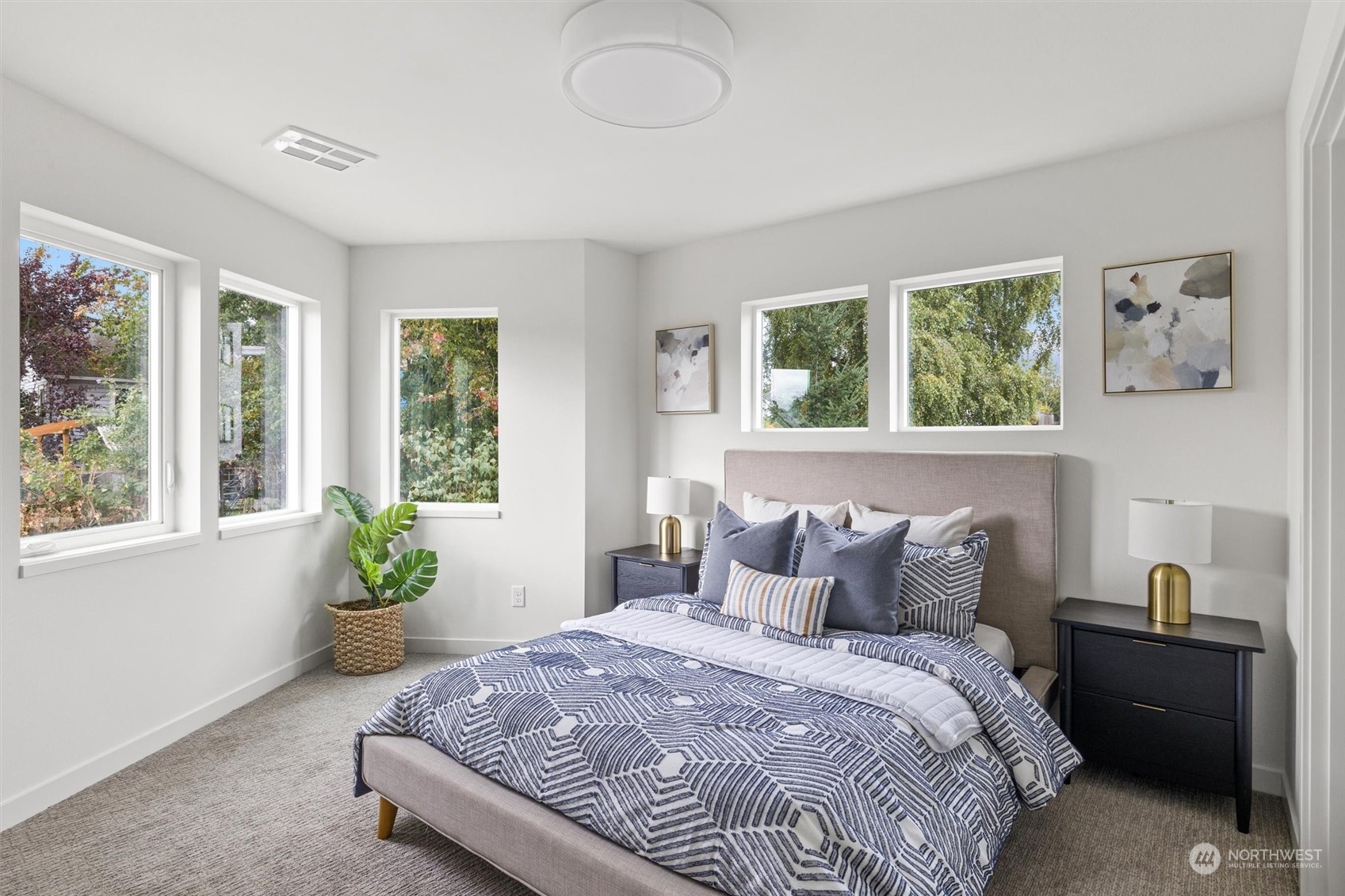 8021 17th Avenue Northwest Seattle, WA 98117 - Photo 17 of 23 a bedroom with a bed and windows