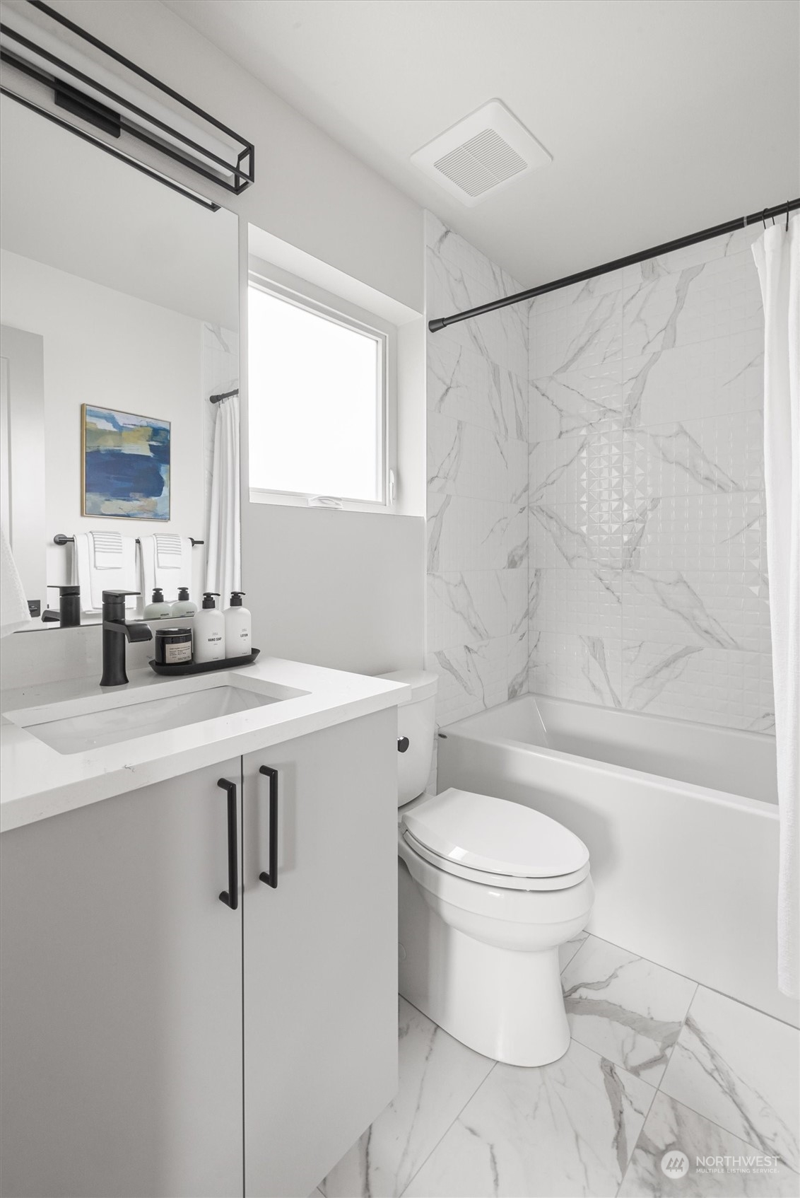 8021 17th Avenue Northwest Seattle, WA 98117 - Photo 21 of 23 a bathroom with a sink a toilet a mirror and a shower