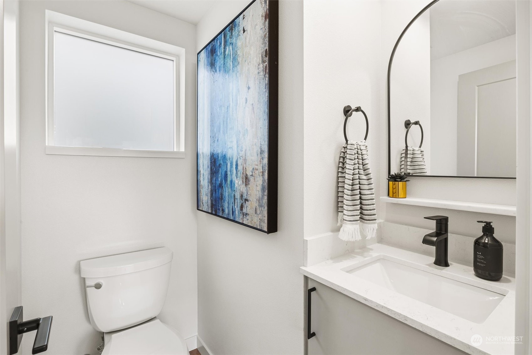 8021 17th Avenue Northwest Seattle, WA 98117 - Photo 9 of 23 a bathroom with a granite countertop sink vanity mirror and toilet