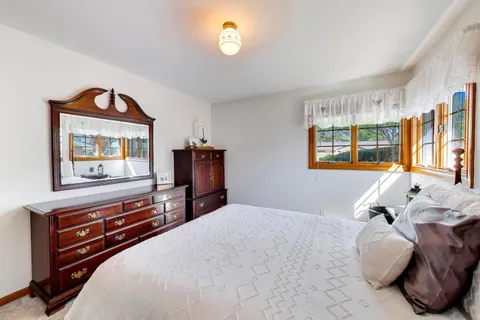 a bedroom with furniture and a flat screen tv
