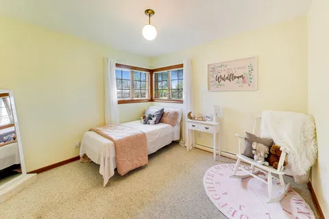 a bedroom with a bed a table and chair